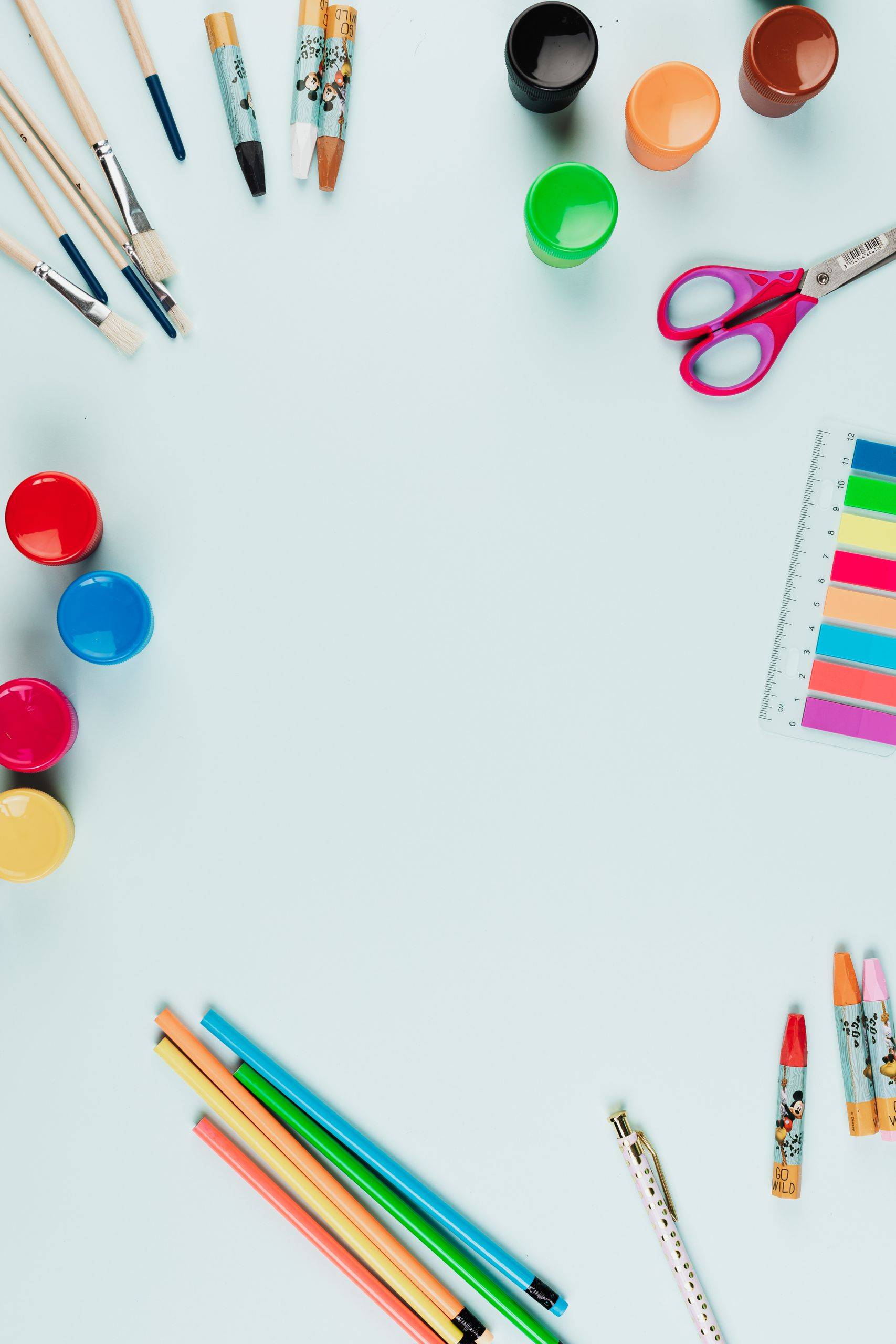 Colorful art materials arranged in a flat lay with ample copy space.